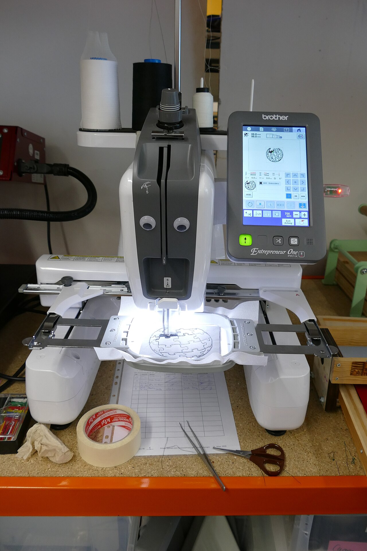 Brother PR multi-needle embroidery machine with touchscreen and hooped fabric