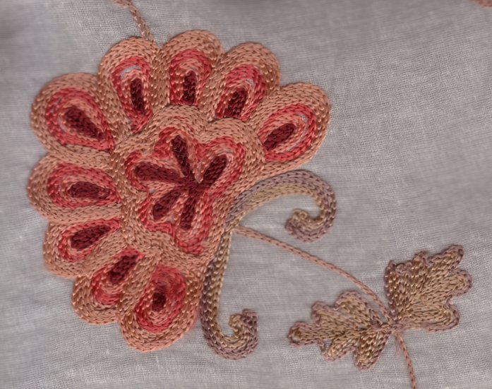 Pink and red chain-stitch flower embroidered on sheer fabric