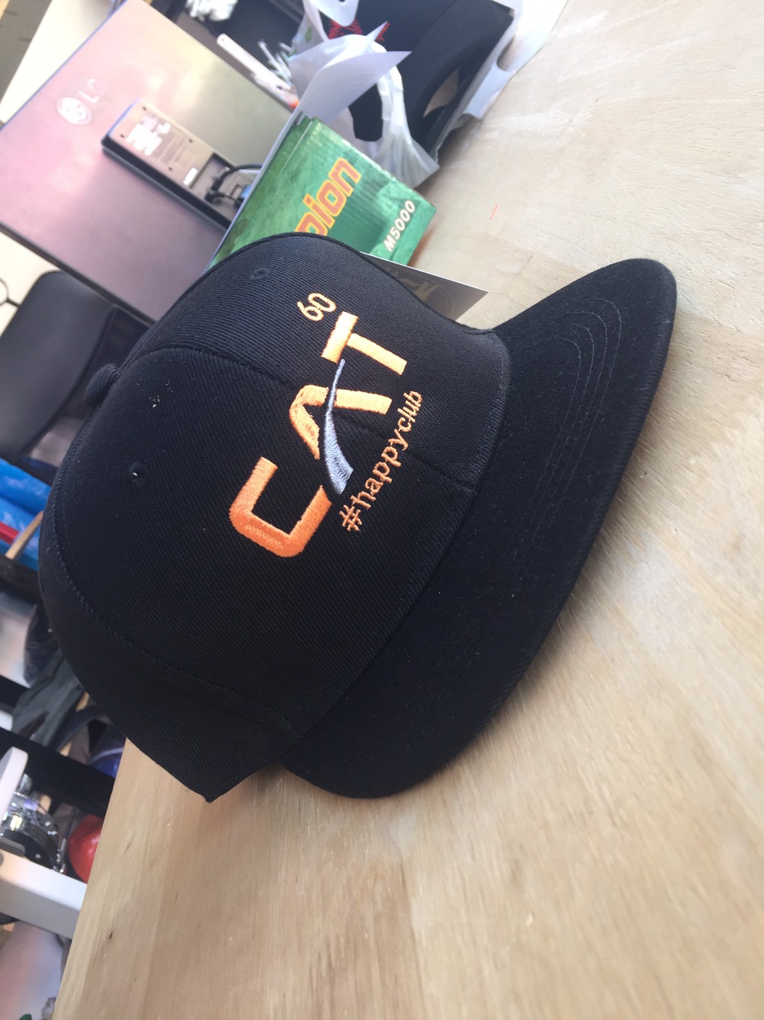 Black cap with orange and white embroidered lettering