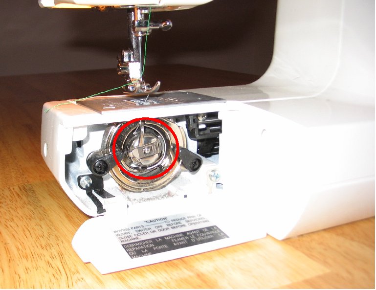 Front-loading rotary hook circled in red on a sewing machine