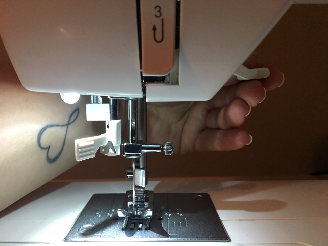 Take-up lever on the front of a sewing machine