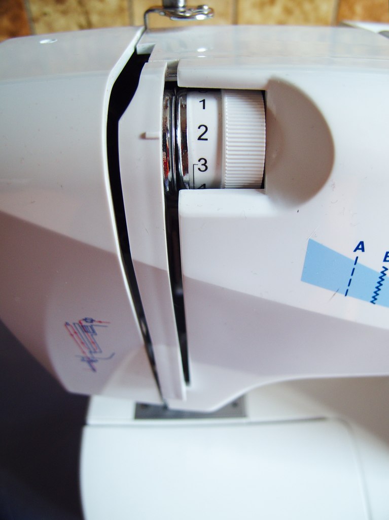 Numbered upper thread tension dial on a sewing machine